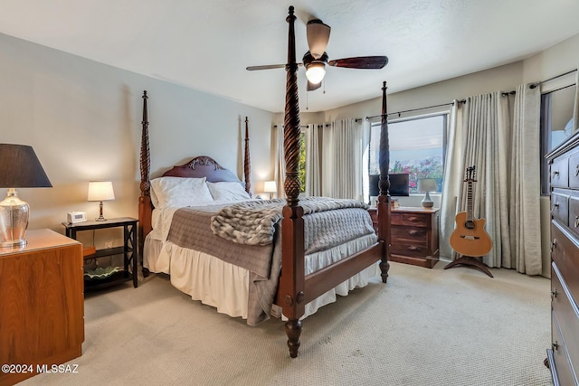 bedroom with ceiling fan, light carpet, and access to outside