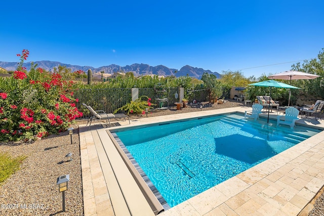 view of pool featuring a mountain view and a patio area