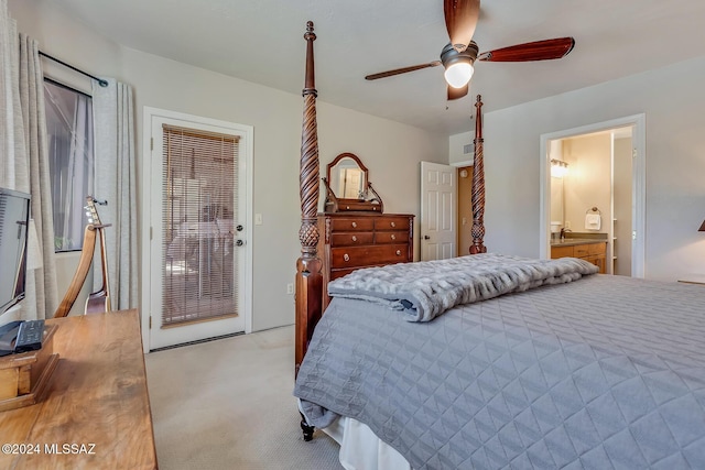 bedroom featuring ensuite bathroom, light colored carpet, and ceiling fan