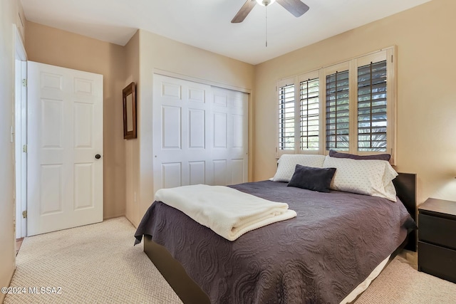 bedroom with light colored carpet, a closet, and ceiling fan