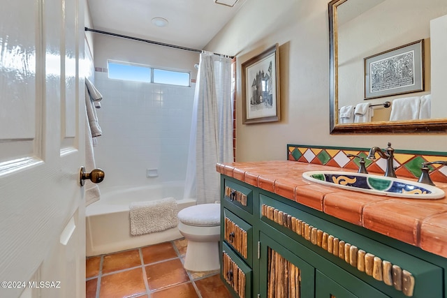 full bathroom featuring shower / tub combo with curtain, vanity, tile patterned floors, and toilet