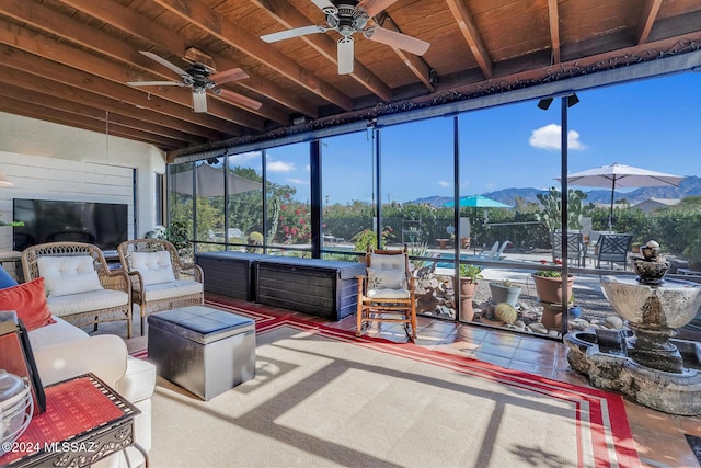 sunroom featuring beamed ceiling, a mountain view, and wood ceiling