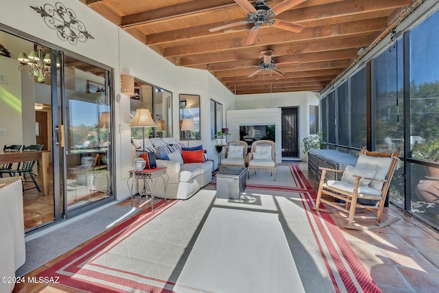 sunroom / solarium with wood ceiling, ceiling fan with notable chandelier, and lofted ceiling with beams