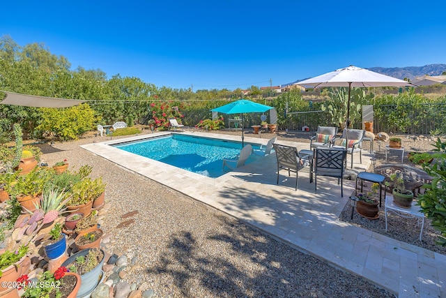 view of pool featuring a mountain view and a patio area