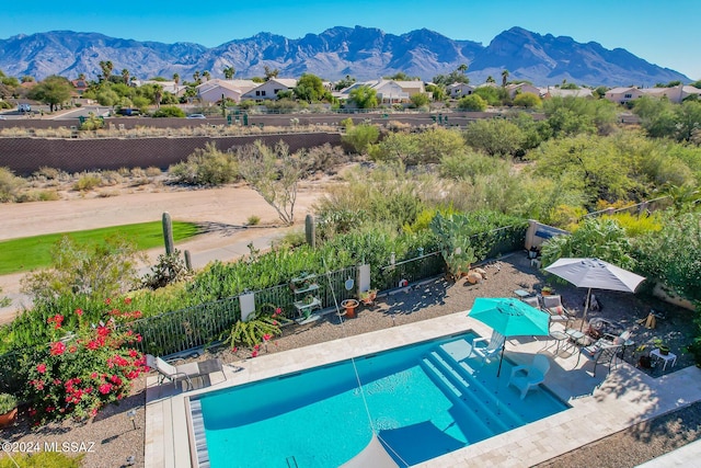 view of pool featuring a mountain view and a patio