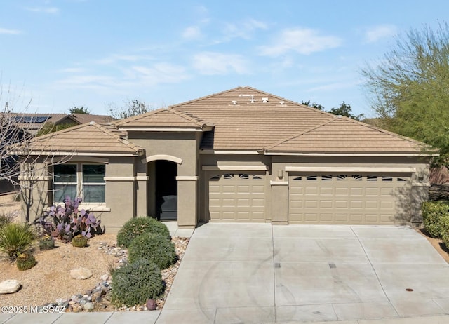 single story home featuring driveway, an attached garage, a tile roof, and stucco siding