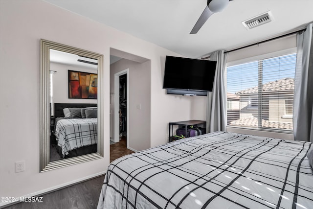 bedroom with ceiling fan and dark hardwood / wood-style flooring