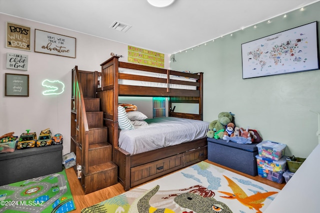 bedroom with hardwood / wood-style flooring