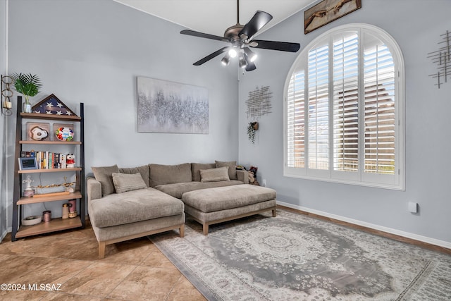 living room with ceiling fan, plenty of natural light, and light tile patterned floors