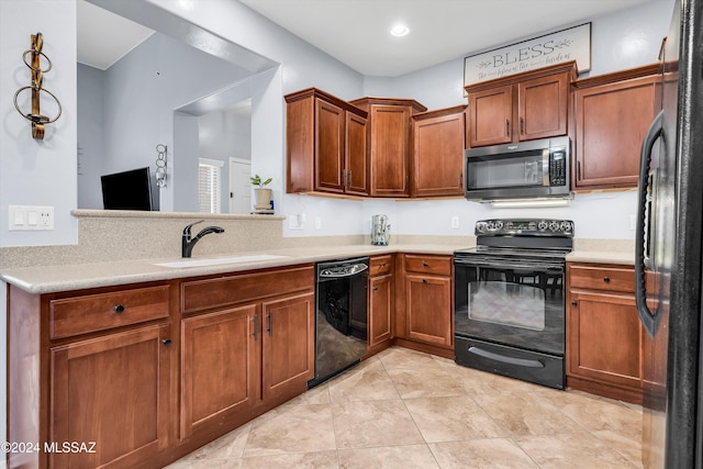 kitchen with light tile patterned floors, sink, and black appliances