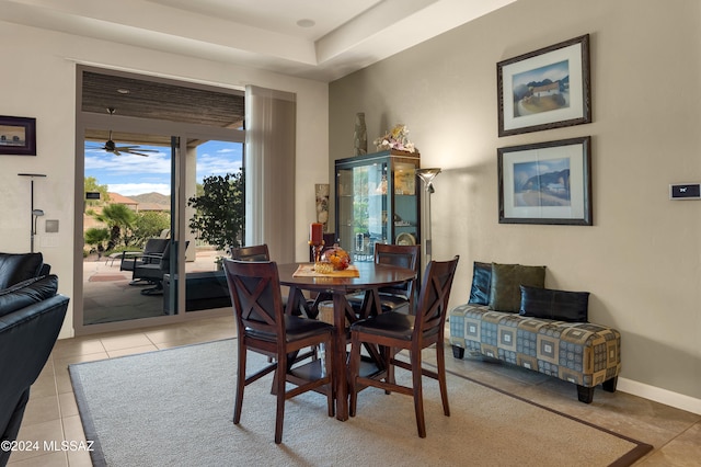 tiled dining space featuring ceiling fan