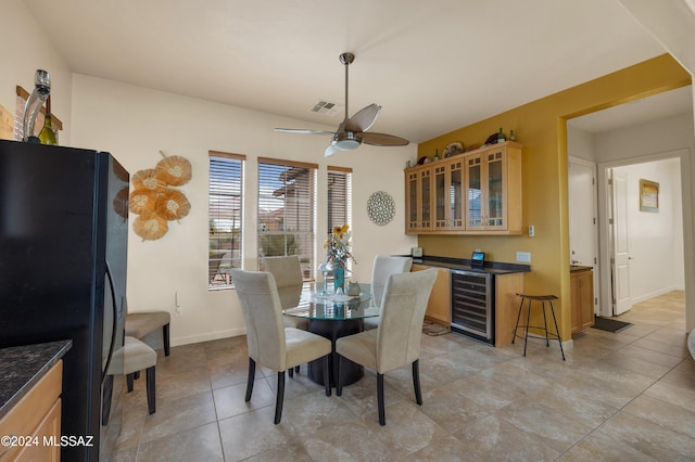 dining area featuring light tile patterned flooring, ceiling fan, and beverage cooler