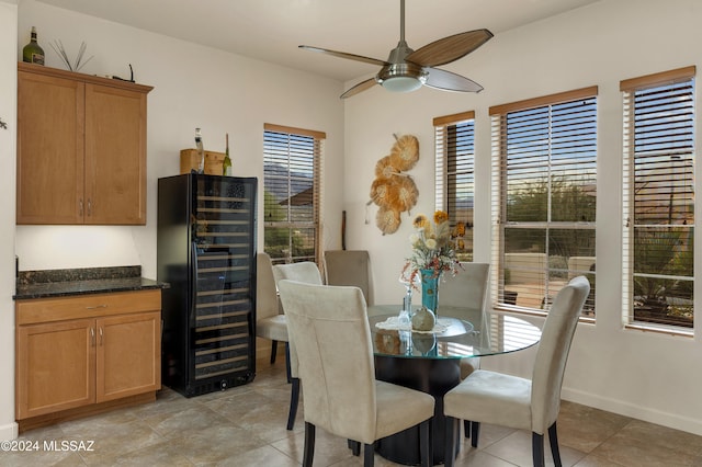 tiled dining space featuring beverage cooler and ceiling fan