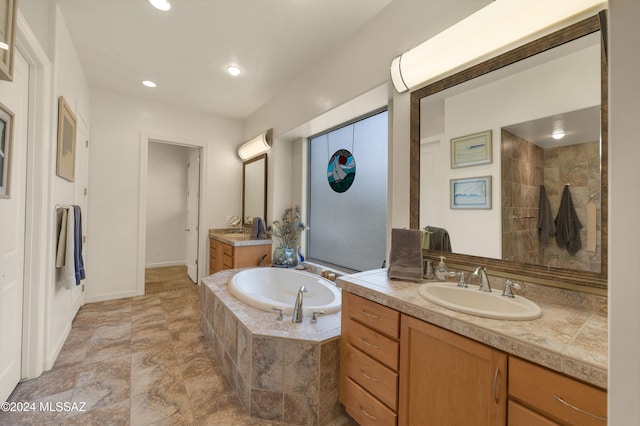 bathroom with shower with separate bathtub and vanity