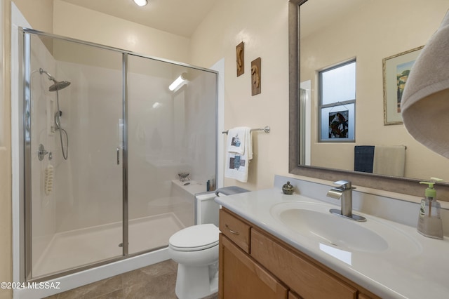 bathroom featuring walk in shower, vanity, tile patterned floors, and toilet