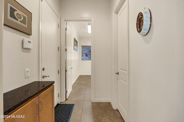 hallway featuring light tile patterned floors