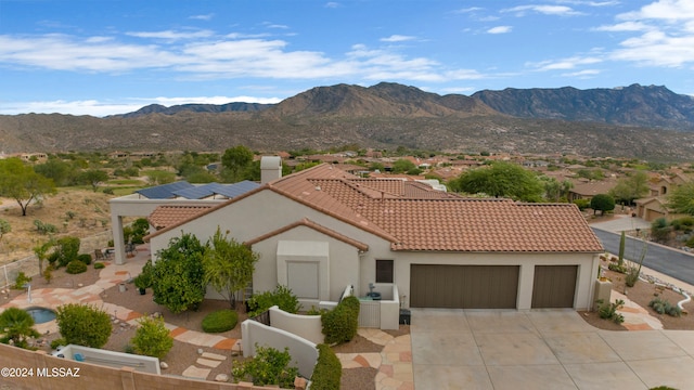 exterior space with a garage and a mountain view