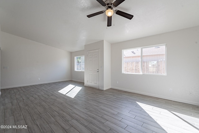 interior space with ceiling fan, light hardwood / wood-style floors, and plenty of natural light