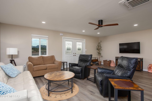 living room featuring ceiling fan and hardwood / wood-style floors