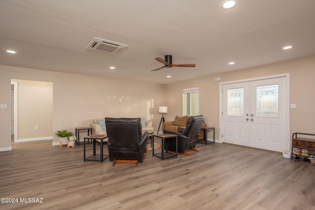 sitting room with hardwood / wood-style flooring and ceiling fan