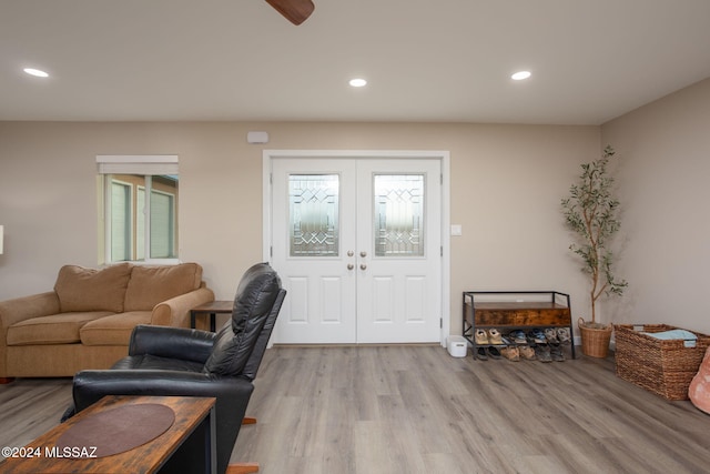 living room featuring french doors and light hardwood / wood-style floors