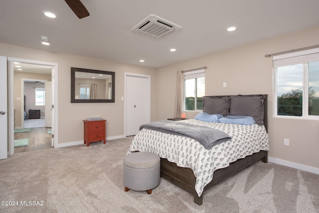 bedroom with light colored carpet and ceiling fan