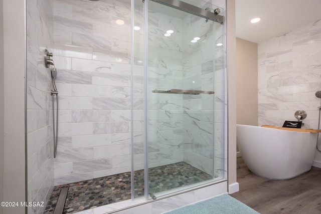 bathroom with hardwood / wood-style floors and plus walk in shower