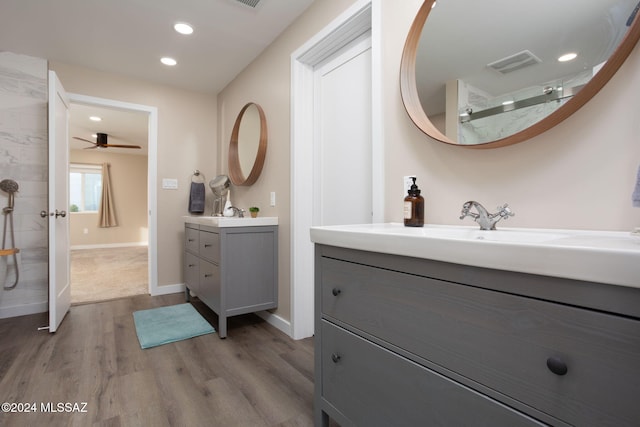 bathroom featuring vanity, ceiling fan, hardwood / wood-style flooring, and a shower
