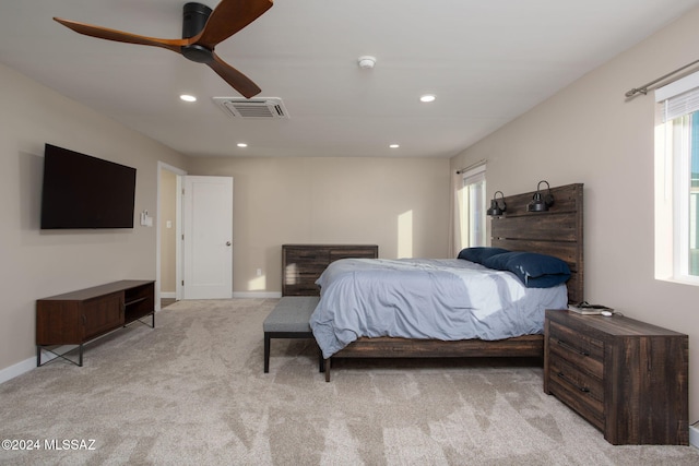 bedroom featuring light colored carpet and ceiling fan