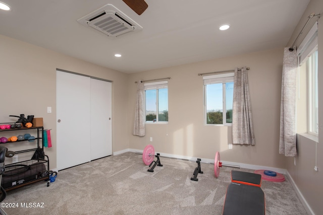 workout room featuring carpet and ceiling fan
