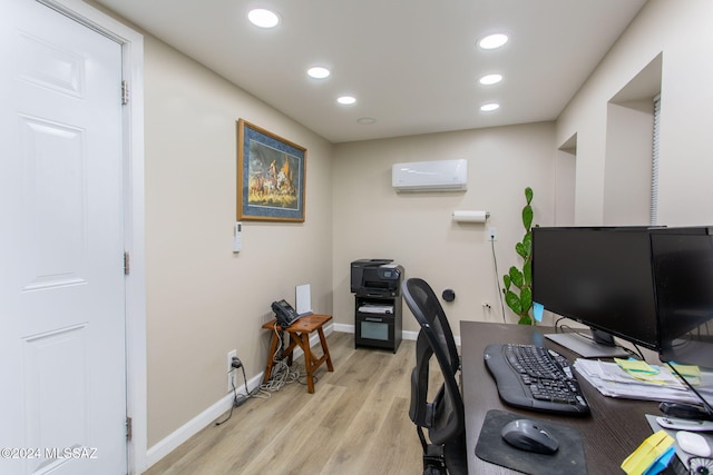office featuring light hardwood / wood-style floors and an AC wall unit