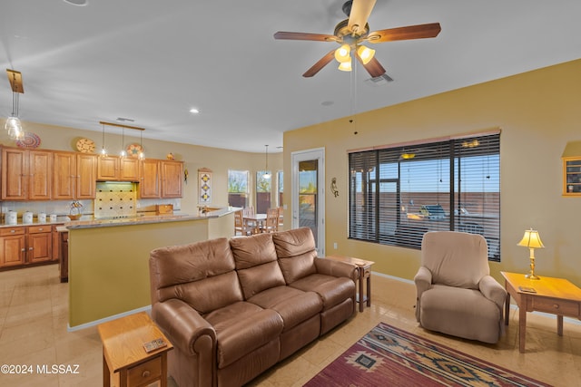 tiled living room with ceiling fan