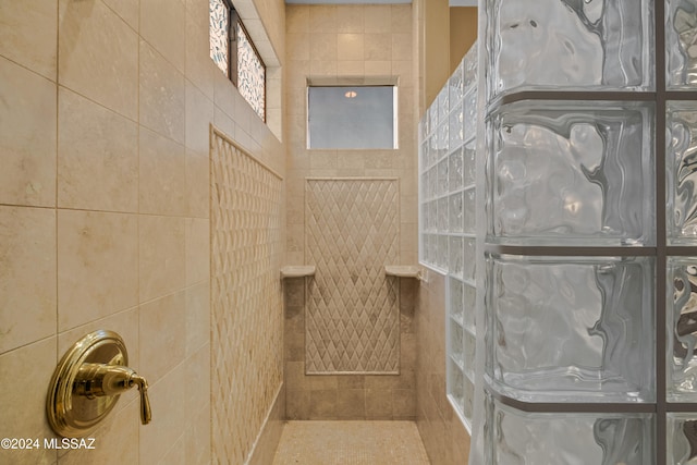 bathroom with a shower and tile patterned flooring