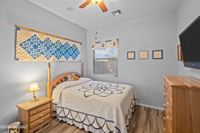 bedroom featuring dark hardwood / wood-style flooring and ceiling fan