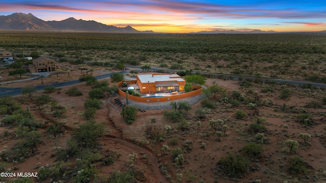 aerial view at dusk featuring a mountain view