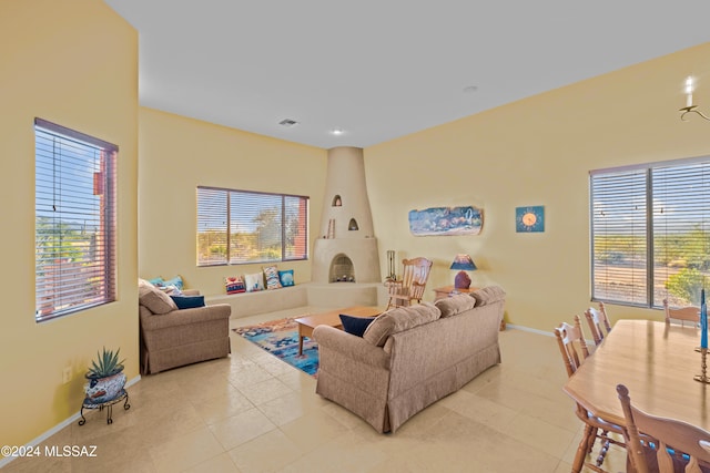 living room featuring a fireplace and light tile patterned floors