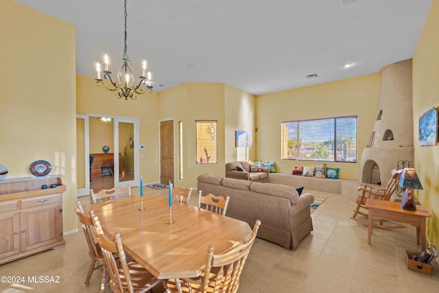 tiled dining room featuring a fireplace and an inviting chandelier