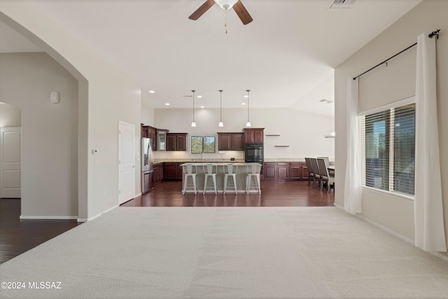 kitchen featuring plenty of natural light, hanging light fixtures, black oven, and a center island