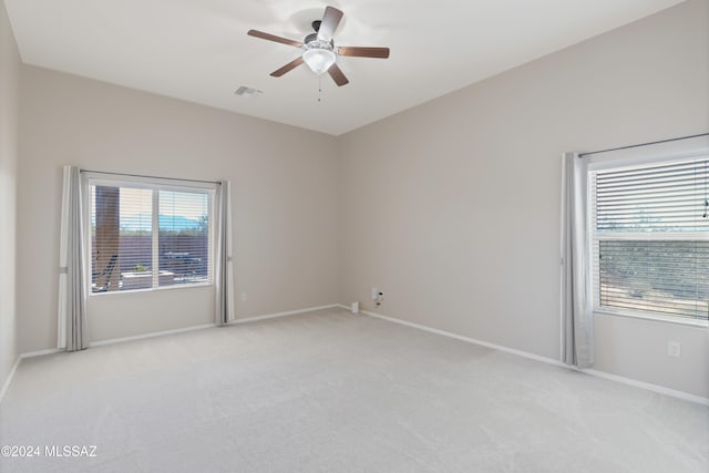 carpeted spare room with ceiling fan