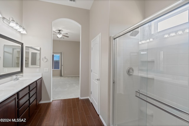 bathroom featuring vanity, hardwood / wood-style flooring, ceiling fan, and a shower with door