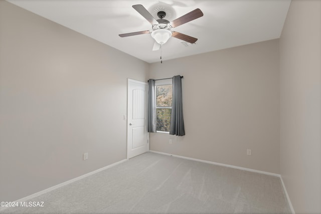 carpeted spare room with ceiling fan