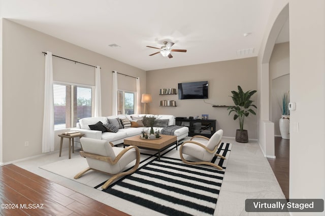 living room with hardwood / wood-style flooring and ceiling fan