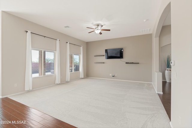 unfurnished living room featuring hardwood / wood-style flooring and ceiling fan