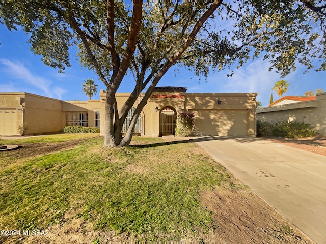 southwest-style home with a garage and a front lawn