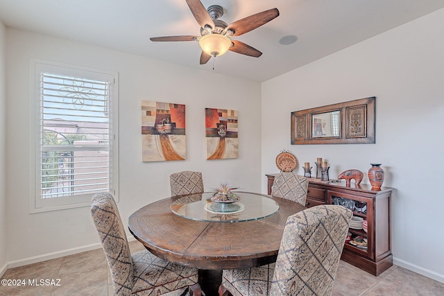 dining room with ceiling fan and light tile patterned flooring