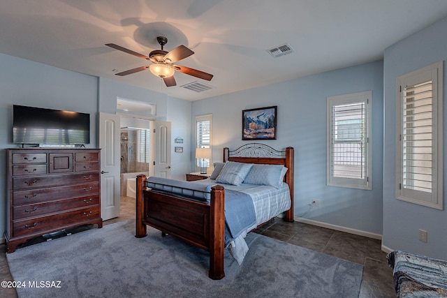 tiled bedroom featuring ceiling fan and ensuite bathroom