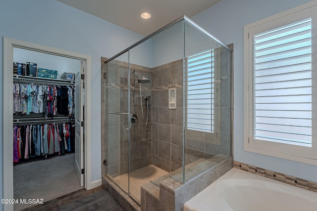 bathroom featuring a healthy amount of sunlight and shower with separate bathtub