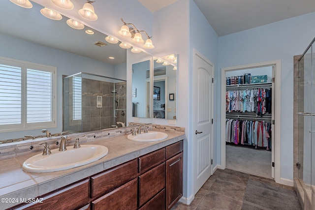 bathroom featuring tile patterned floors, vanity, and walk in shower