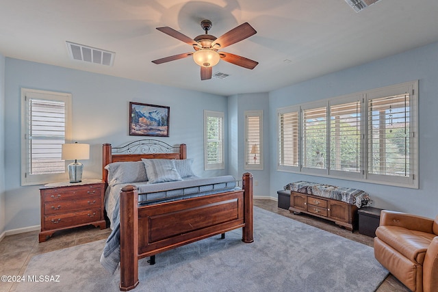 bedroom with ceiling fan and light tile patterned flooring