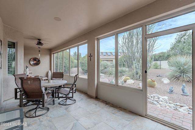 sunroom / solarium featuring ceiling fan and a wealth of natural light